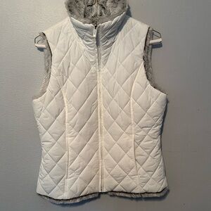 White vest with gray fur inside.